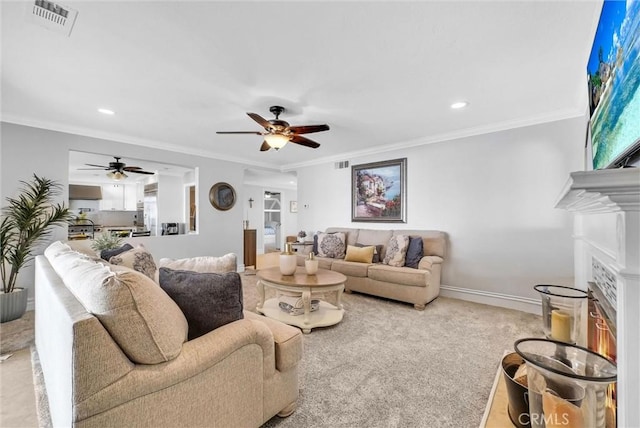 2622 S Pacific Ave, Santa Ana, CA 92704 - living room featuring a ceiling fan, crown molding, a fireplace, recessed lighting, and light colored carpet