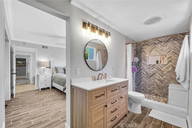 2622 S Pacific Ave, Santa Ana, CA 92704 - full bathroom featuring wood tiled floors, vanity, tiled shower, and ensuite bathroom
