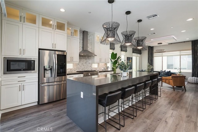 35 Ebb Tide Cir, Newport Beach, CA 92663 - kitchen with stainless steel fridge with ice dispenser, wall chimney exhaust hood, built in microwave, dark countertops, and wood finished floors