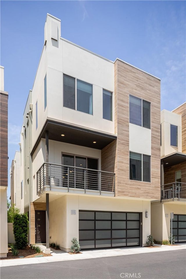 35 Ebb Tide Cir, Newport Beach, CA 92663 - view of front of property featuring a garage, stucco siding, and a balcony