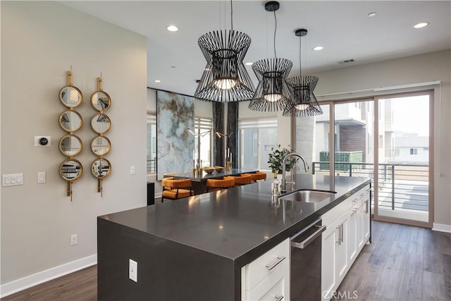 35 Ebb Tide Cir, Newport Beach, CA 92663 - kitchen featuring dark countertops, dark wood finished floors, an island with sink, recessed lighting, and white cabinetry