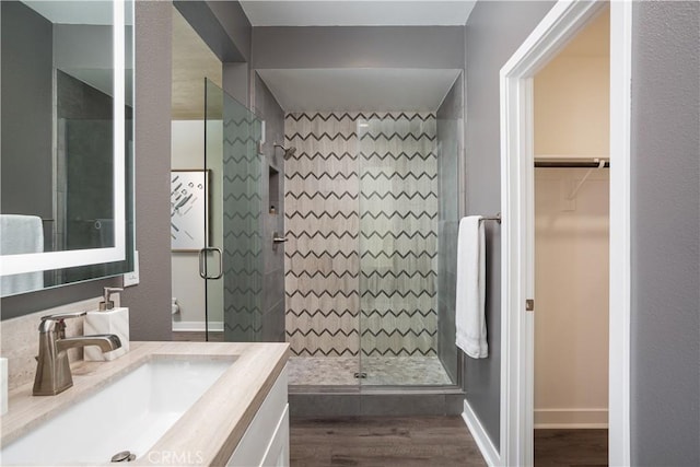 35 Ebb Tide Cir, Newport Beach, CA 92663 - full bathroom with wood finished floors, vanity, a shower stall, and a walk in closet