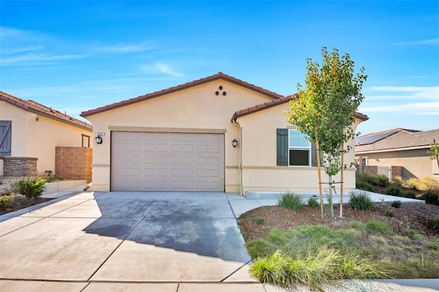 41207 Alegria Ln, Lake Elsinore, CA 92532 - mediterranean / spanish house featuring stucco siding, an attached garage, concrete driveway, and a tiled roof