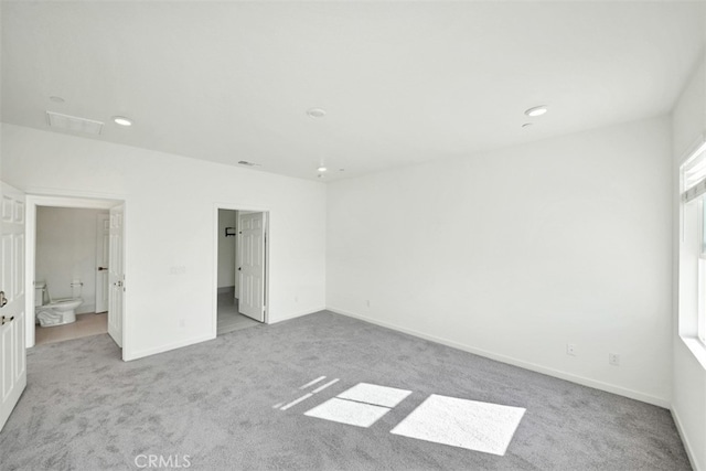 41207 Alegria Ln, Lake Elsinore, CA 92532 - unfurnished bedroom featuring light colored carpet, connected bathroom, and recessed lighting