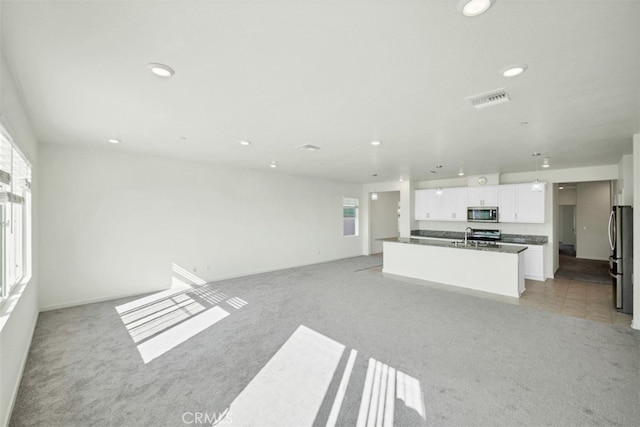 41207 Alegria Ln, Lake Elsinore, CA 92532 - unfurnished living room featuring light carpet, plenty of natural light, and recessed lighting