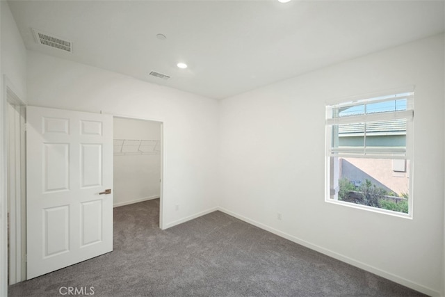41207 Alegria Ln, Lake Elsinore, CA 92532 - unfurnished bedroom featuring dark colored carpet, a spacious closet, a closet, and recessed lighting