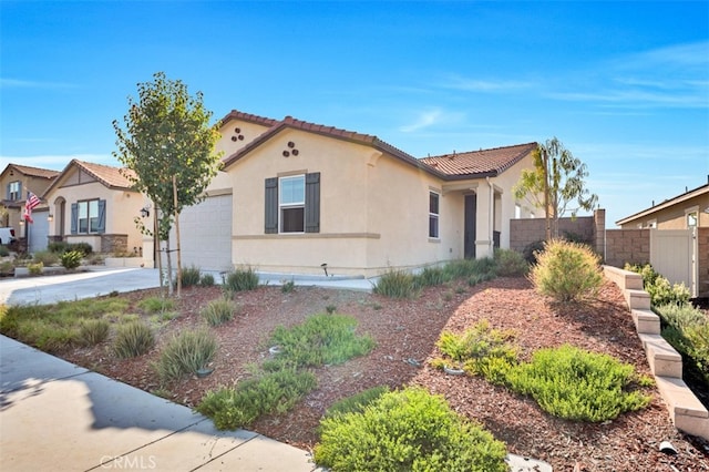 41207 Alegria Ln, Lake Elsinore, CA 92532 - mediterranean / spanish house with stucco siding, a garage, a tiled roof, and concrete driveway