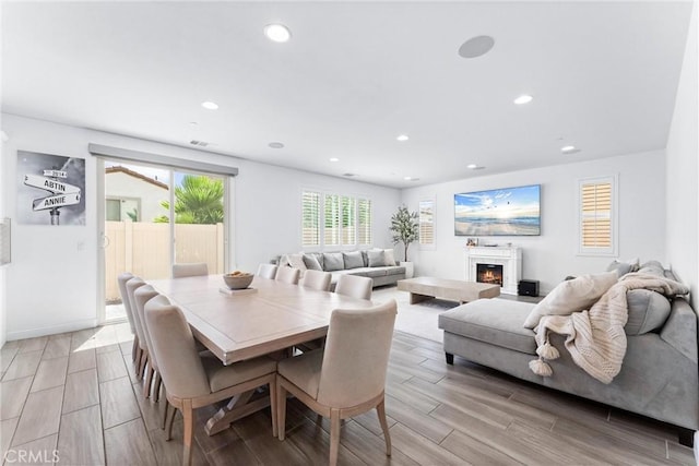 2825 Villa Catalonia Ct, Corona, CA 92881 - dining area featuring recessed lighting, wood finish floors, and a lit fireplace