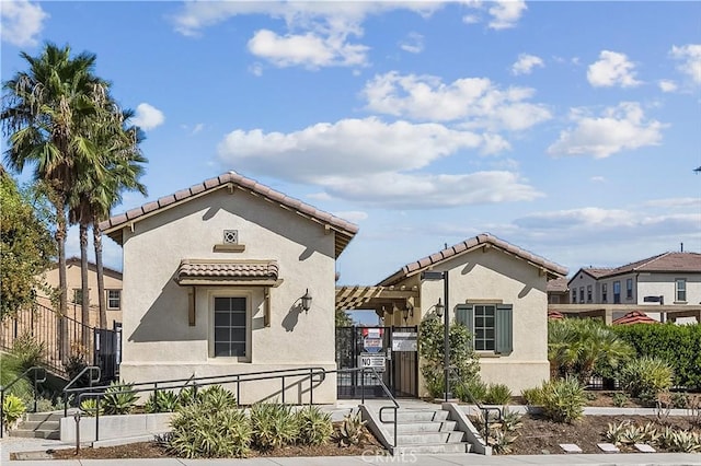 2825 Villa Catalonia Ct, Corona, CA 92881 - mediterranean / spanish-style home with stucco siding, a tiled roof, and a gate