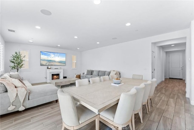 2825 Villa Catalonia Ct, Corona, CA 92881 - dining space with wood finish floors, recessed lighting, healthy amount of natural light, and a lit fireplace