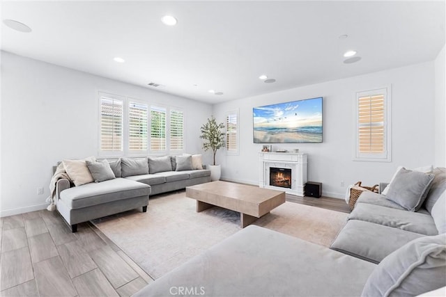 2825 Villa Catalonia Ct, Corona, CA 92881 - living area featuring recessed lighting, light wood finished floors, and a warm lit fireplace