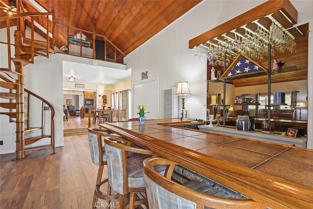 3110 N Greenbrier Rd, Long Beach, CA 90808 - bar area with high vaulted ceiling, wooden ceiling, hardwood / wood-style floors, and stairs