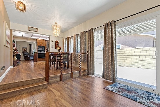 3110 N Greenbrier Rd, Long Beach, CA 90808 - dining room featuring a chandelier and wood finished floors