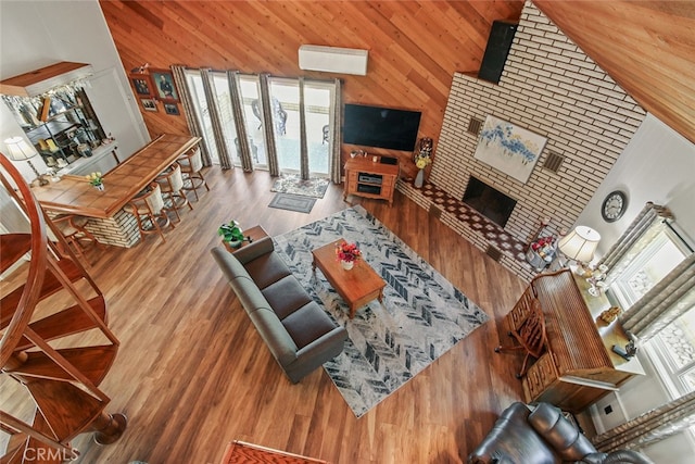 3110 N Greenbrier Rd, Long Beach, CA 90808 - living area with healthy amount of natural light, high vaulted ceiling, wood walls, wood finished floors, and an AC wall unit