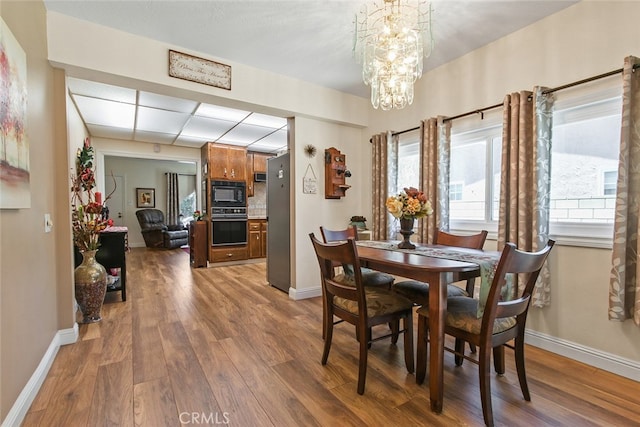 3110 N Greenbrier Rd, Long Beach, CA 90808 - dining space with wood finished floors and a chandelier