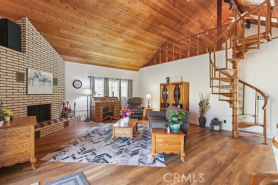 3110 N Greenbrier Rd, Long Beach, CA 90808 - living room featuring high vaulted ceiling, stairs, wood finished floors, wooden ceiling, and a brick fireplace