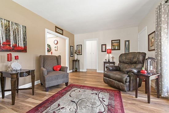 3110 N Greenbrier Rd, Long Beach, CA 90808 - living room with light wood-style flooring and baseboards