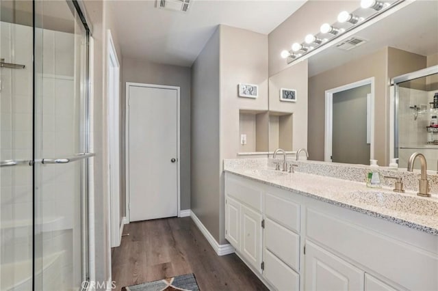 1519 Bluejay Way, Hemet, CA 92545 - full bathroom with a stall shower, double vanity, and wood finished floors