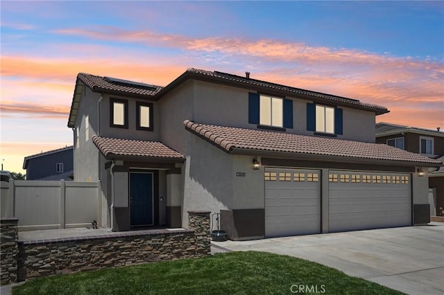 1519 Bluejay Way, Hemet, CA 92545 - mediterranean / spanish home with driveway, a tile roof, a garage, stucco siding, and solar panels