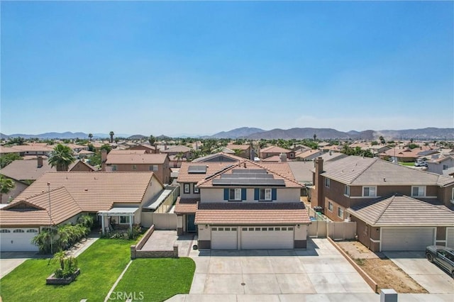 1519 Bluejay Way, Hemet, CA 92545 - view of front facade featuring a residential view, a tile roof, stucco siding, driveway, and roof mounted solar panels