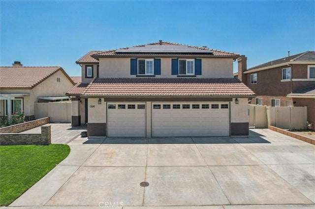 1519 Bluejay Way, Hemet, CA 92545 - mediterranean / spanish-style house with concrete driveway, a garage, stucco siding, solar panels, and a tiled roof