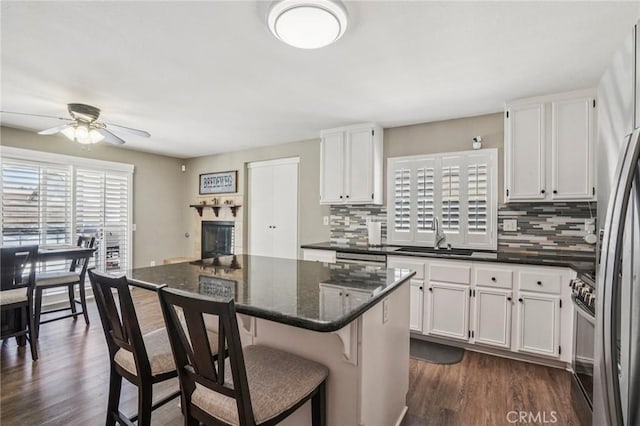 1519 Bluejay Way, Hemet, CA 92545 - kitchen featuring ceiling fan, appliances with stainless steel finishes, backsplash, and white cabinets