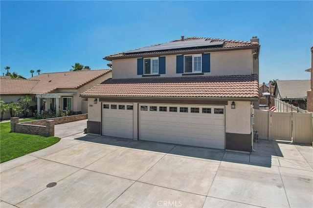 1519 Bluejay Way, Hemet, CA 92545 - mediterranean / spanish-style house with driveway, a tiled roof, solar panels, stucco siding, and a gate