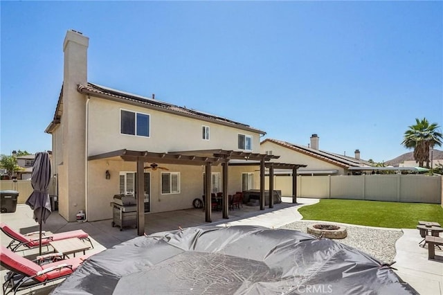1519 Bluejay Way, Hemet, CA 92545 - back of property featuring an outdoor fire pit, a fenced backyard, a pergola, a ceiling fan, and stucco siding