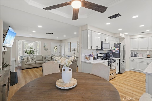 1443 E Devonshire Ave, Hemet, CA 92544 - dining space featuring light wood-style flooring, recessed lighting, a ceiling fan, ornamental molding, and a raised ceiling