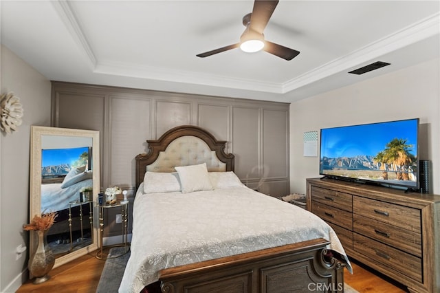 1443 E Devonshire Ave, Hemet, CA 92544 - bedroom with wood finished floors, a raised ceiling, crown molding, and a ceiling fan