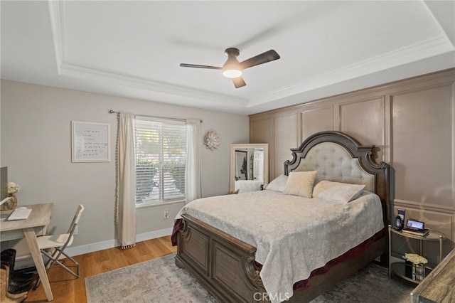1443 E Devonshire Ave, Hemet, CA 92544 - bedroom with a raised ceiling, light wood-style flooring, and a ceiling fan