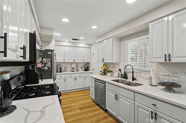 1443 E Devonshire Ave, Hemet, CA 92544 - kitchen with dishwasher, range with gas cooktop, white cabinetry, and recessed lighting