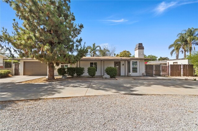 1443 E Devonshire Ave, Hemet, CA 92544 - ranch-style home featuring concrete driveway, a chimney, stucco siding, and a garage