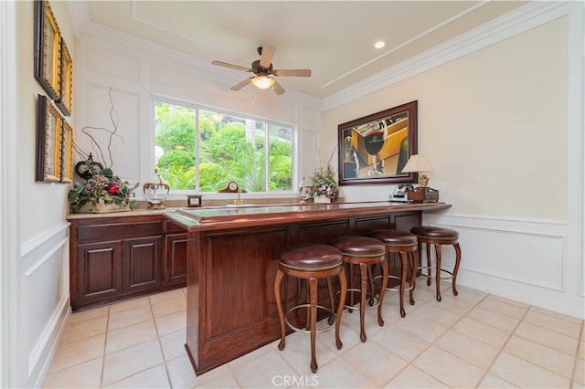 2809 Oak Knoll Dr, Diamond Bar, CA 91765 - indoor bar featuring a decorative wall, ornamental molding, a ceiling fan, wainscoting, and light tile patterned floors