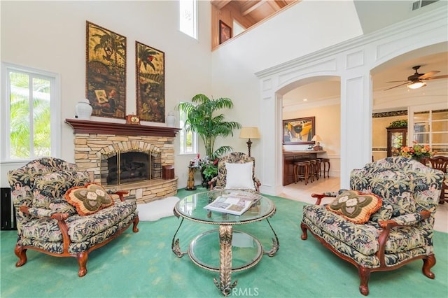 2809 Oak Knoll Dr, Diamond Bar, CA 91765 - carpeted living area featuring a fireplace, ceiling fan, a high ceiling, arched walkways, and crown molding