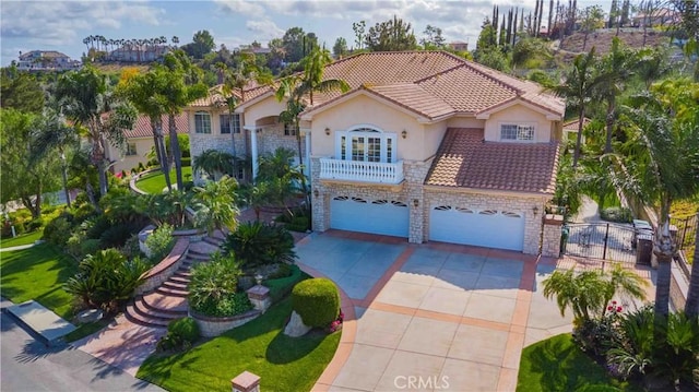 2809 Oak Knoll Dr, Diamond Bar, CA 91765 - mediterranean / spanish-style house with concrete driveway, a tiled roof, stone siding, an attached garage, and stucco siding