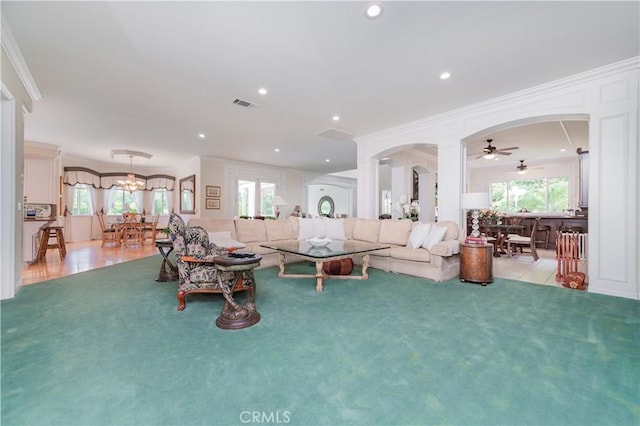 2809 Oak Knoll Dr, Diamond Bar, CA 91765 - living area featuring arched walkways, ornamental molding, a ceiling fan, healthy amount of natural light, and light colored carpet