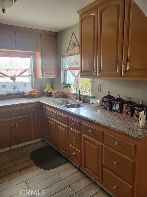 1140 W Cubbon St, Santa Ana, CA 92703 - kitchen with light wood-type flooring and light stone counters