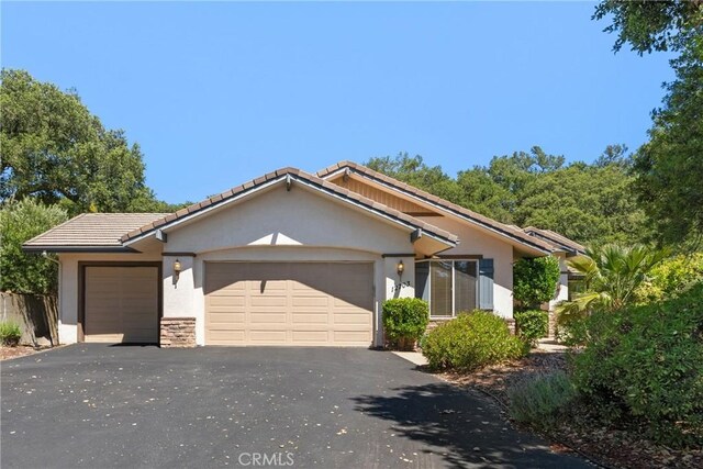 12703 Paso Verde Ct, Atascadero, CA 93422 - view of front of home featuring stucco siding, an attached garage, a tile roof, and asphalt driveway