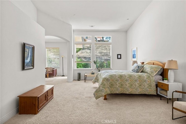 12703 Paso Verde Ct, Atascadero, CA 93422 - bedroom featuring arched walkways, multiple windows, and light colored carpet