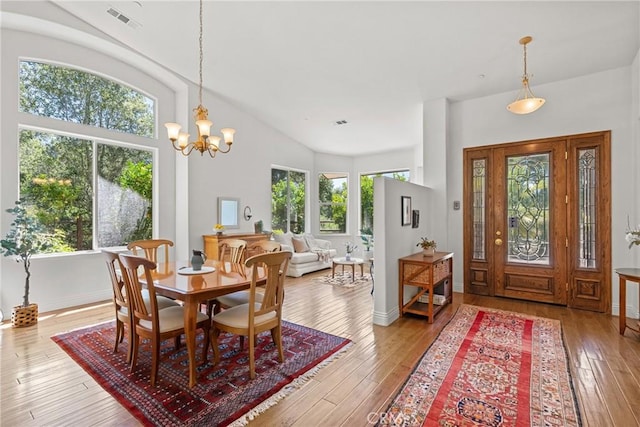 12703 Paso Verde Ct, Atascadero, CA 93422 - dining room with hardwood / wood-style floors, a chandelier, and vaulted ceiling