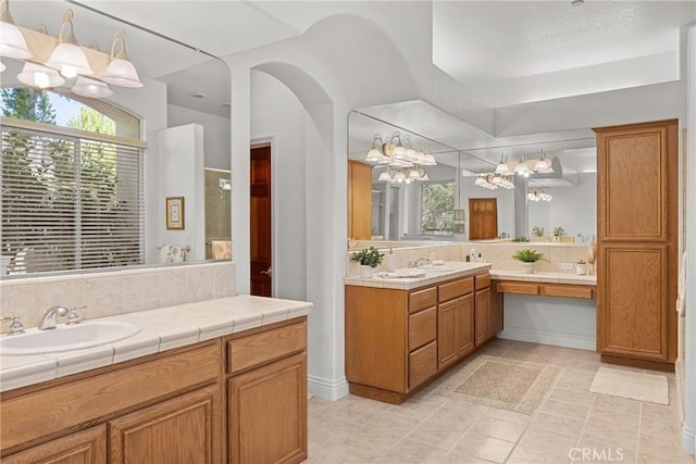 12703 Paso Verde Ct, Atascadero, CA 93422 - full bath featuring a chandelier, plenty of natural light, vanity, and tile patterned flooring