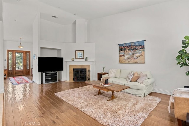 12703 Paso Verde Ct, Atascadero, CA 93422 - living room with wood finished floors, a tiled fireplace, and a high ceiling