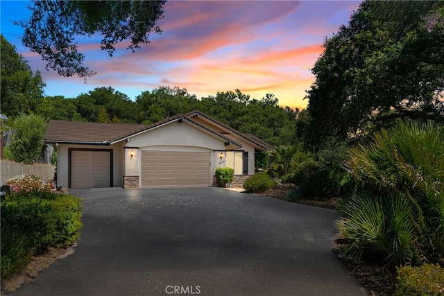 12703 Paso Verde Ct, Atascadero, CA 93422 - ranch-style house with asphalt driveway, an attached garage, stucco siding, and stone siding