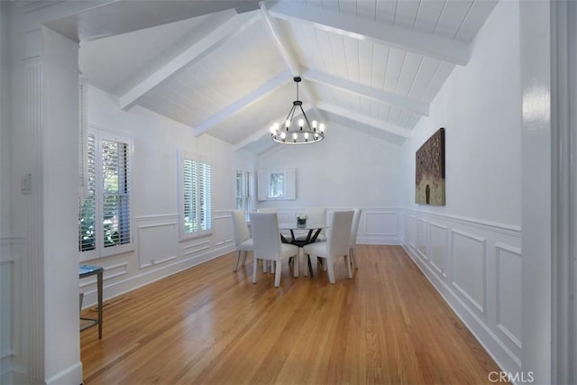 4161 Dixie Canyon Ave, Sherman Oaks, CA 91423 - dining room featuring a chandelier, a decorative wall, light wood-style floors, and a wainscoted wall