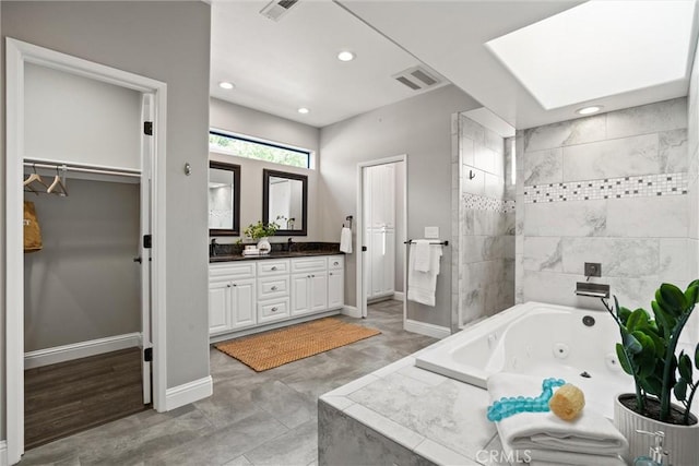 5 Catalina Point Rd, Chico, CA 95928 - bathroom with double vanity, a tub with jets, a tile shower, recessed lighting, and a walk in closet