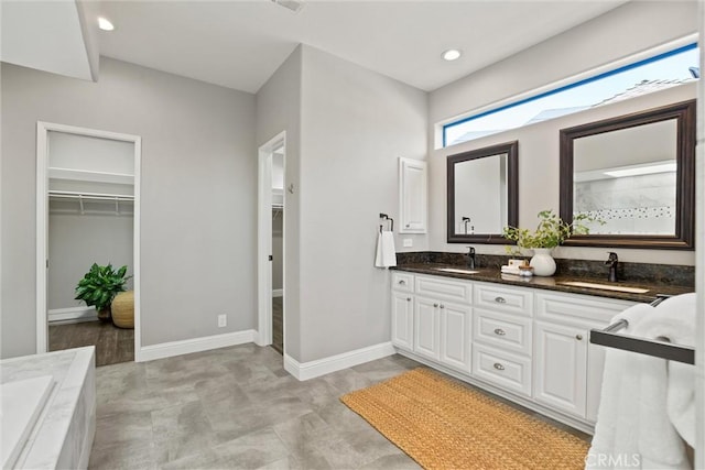 5 Catalina Point Rd, Chico, CA 95928 - bathroom with double vanity, a walk in closet, a tub to relax in, and recessed lighting
