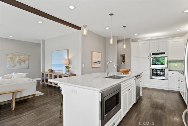 5 Catalina Point Rd, Chico, CA 95928 - kitchen featuring stainless steel appliances, dark wood finished floors, a kitchen island with sink, recessed lighting, and white cabinets