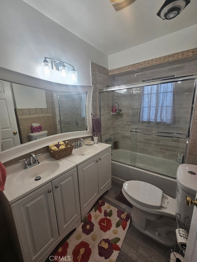 8686 San Juan Ave, South Gate, CA 90280 - bathroom featuring enclosed tub / shower combo, double vanity, and wood finished floors
