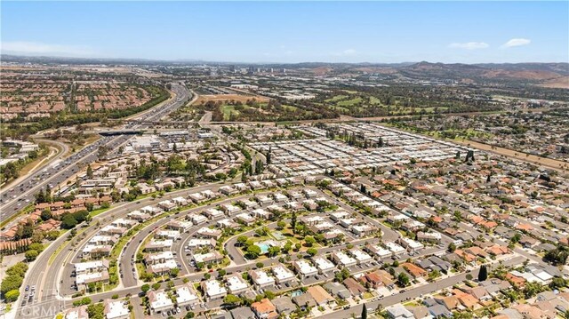 54 Kazan St Unit 27, Irvine, CA 92604 - aerial view of property and surrounding area featuring nearby suburban area and a mountain backdrop